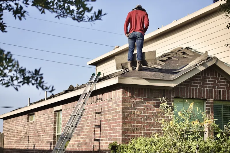 Professional roofer working on a residential roof in Laurel